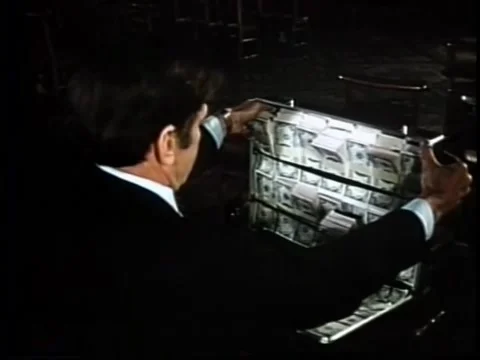 Rear view of man opening briefcase filled with cash Stock Footage 260247673