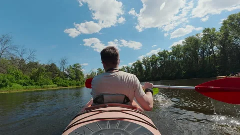 Rear view of man paddling tandem kayak on calm river for outdoor adventure .. Stock Footage 344869079