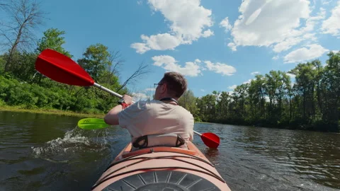Rear view of man paddling tandem kayak on calm river for outdoor adventure .. Stock Footage 345582471