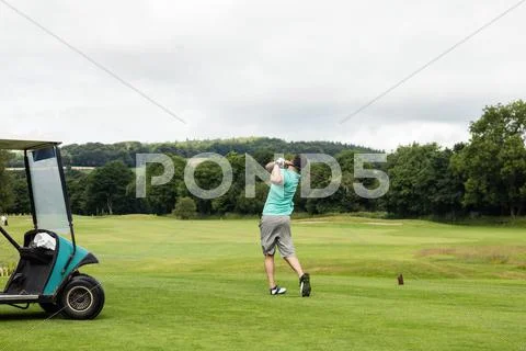 Rear View Of Man Playing Golf