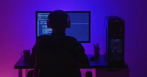 Rear view of man programmer in headphones coding network security software Stock Footage 152368746