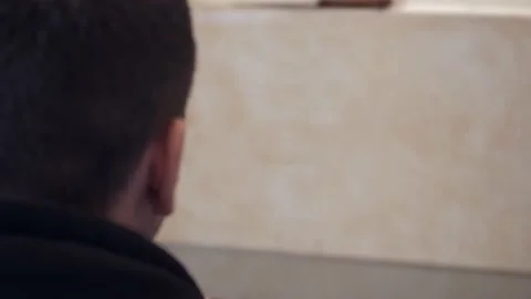 Rear view of a man puts a bullet in a gun puts a gun to his head and is ready to Stock Footage 237870159