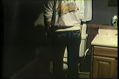 Rear view of man relieving himself in broken toilet 스톡 동영상 11354349