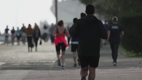 Rear view of a man running a marathon Stock Footage 306440532