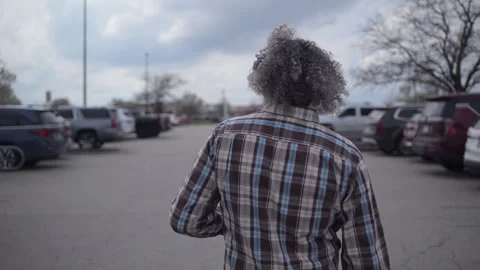 Rear view of man seen walking in parking lot Stock-Footage 333041342