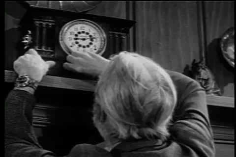 Rear view of man trying to wind antique clock Stock Footage 14524830