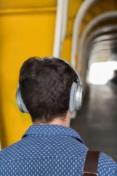 Rear View Of Man In Urban Setting Wearing Headphones Stock Photos