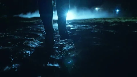 Rear view of a man walking down a dark street through fog and gloom Stock Footage 237119204