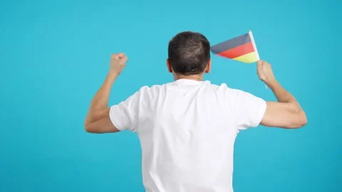 Rear view of a man waving a german pennant Video stock 252484787