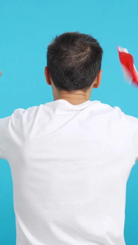 Rear view of a man waving a peruvian pennant Stock Footage 257323672