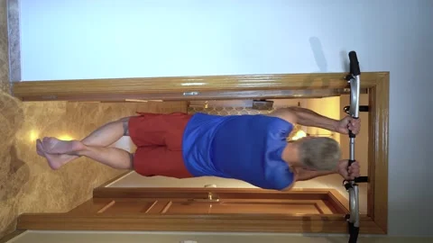 Rear view of a man working out at home doing chin-ups Stock Footage 149402944