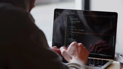 Rear view of a man writing code on his laptop. Close-up of a male web Stock Footage 236643766