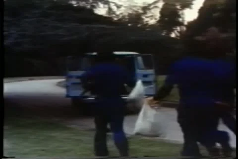 Rear view men running into getaway car with loot after robbery Stock Footage 11346446