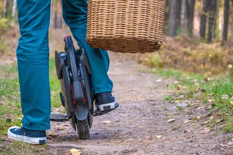 Rear view of men's legs on an electric unicycle Stock Photos