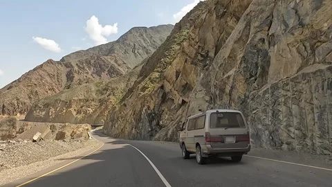 Rear view of a minivan driving along an amazing mountain road Video stock 241381908