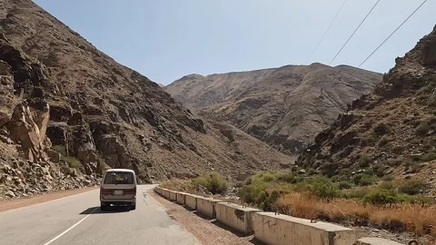 Rear view of a minivan driving through a beautiful mountain gorge Video stock 241381567