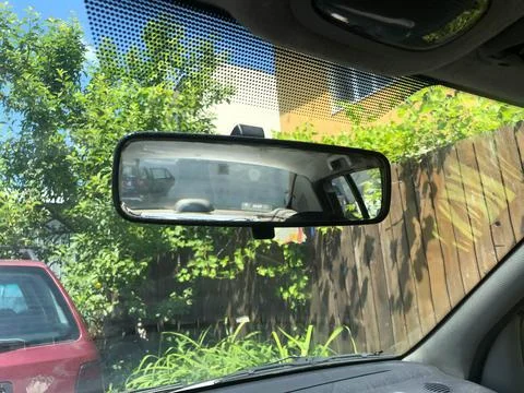 Rear view mirror adjusted on the windshield Stock Photos