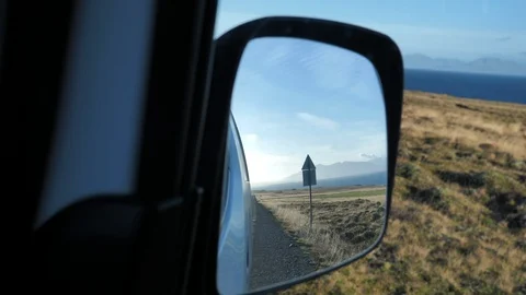 Rear-view mirror car view in an Iceland Road Stock Footage 85951842