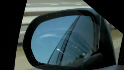 Rear view mirror of the car while driving on the highway Stock Footage 113399429