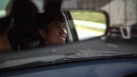 Rear view mirror. Close up shot eye of Happy young asian man looking roadway. Stock Footage 233234971