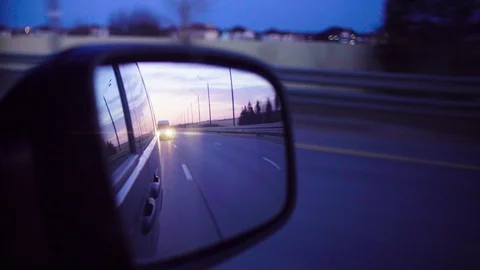 Rear view mirror in a moving car at evening. Video stock 88791876
