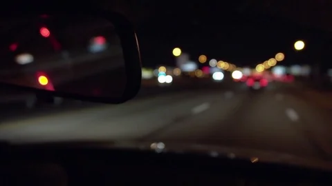 Rear view mirror at night driving on the highway Stock Footage 77810133