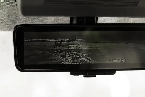 The rear view mirror with screen inside the car. Stock Photos