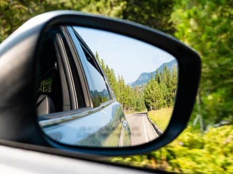 Rear view mirror view while driving through the Rocky Mountains of Colorado. Stock Photos