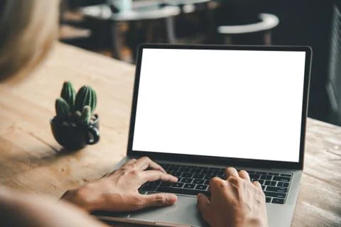 Rear view mockup image of a woman's hand working on a laptop with blank white Stock Photos