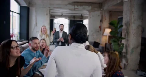 Rear view multiethnic team is clapping to celebrate successful African leader Stock Footage 133711966