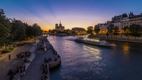 Rear view of Notre Dame De Paris cathedral day to night timelapse after sunse Stock Photos
