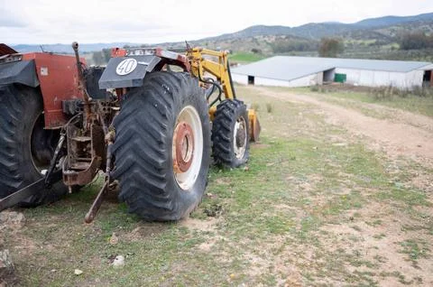 Rear view of an old tractor to work the land of the agricultural field Stock Photos