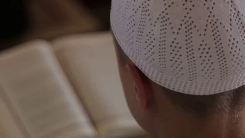 Rear view of one boy learning the Quran. Video stock 80338901