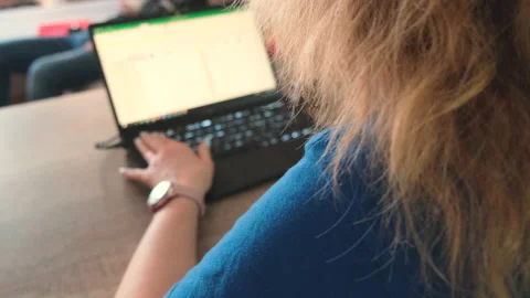 Rear view over the shoulder working with a laptop woman Video stock 134170119