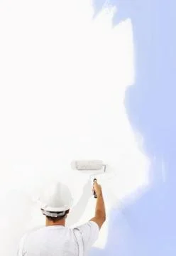 Rear view of painter man with paint roller painting on blank wall, isolated o Stock Photos