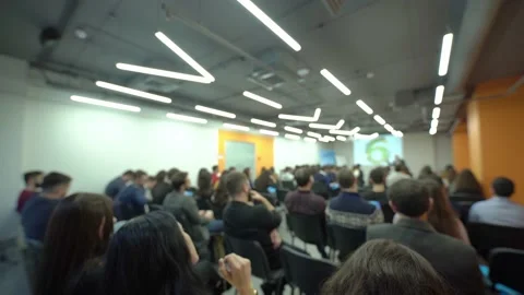 Rear view of people at a presentation, seminar or forum. Stock Footage 198518551