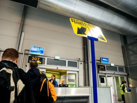 Rear view of people waiting in queue boarding airport Stock Photos