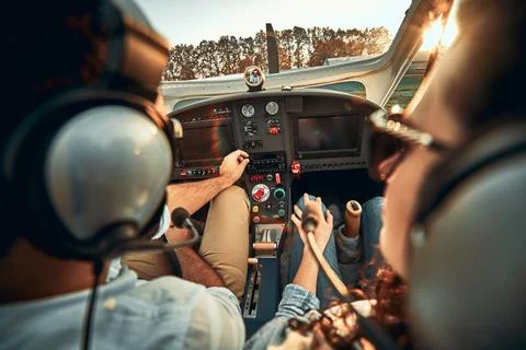 Rear view of pilot and copilot in private cockpit of small plane Stock Photos