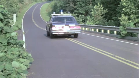 Rear view of police car chase on country road Stock Footage