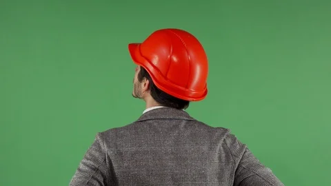 Rear view portrait of a contractor wearing hardhat looking at the green screen Stock Footage 93237652