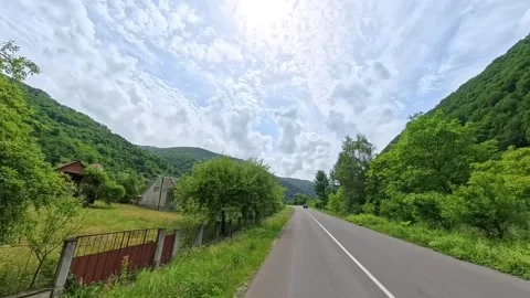 Rear view POV shot from a moving vehicle showing a clean asphalt road receding Vídeo Stock 346180975