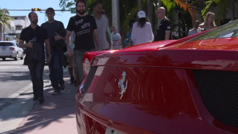 Rear View of Red Ferrari Parked on Street as Pedestrians Walk By Stock Footage 342563129