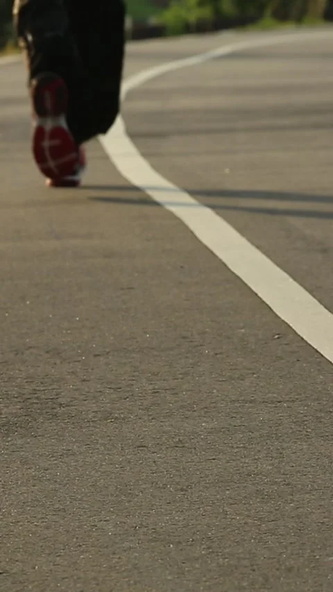 Rear view Road runner Male Legs Feet Running on road urban city with sunset Stock Footage 315520433