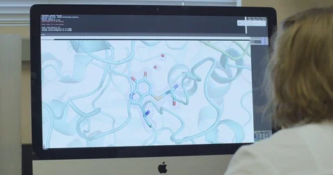 Rear view of scientist checking molecular model on computer Stock Footage 104340979