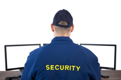 Rear view of security officer using computer Stock Photos