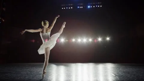 Rear view of serious ballet dancer in costume performing onstage in show 库存照片