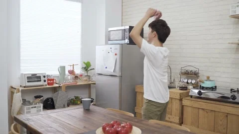 Rear view shot boy walking into the kitchen Stock Footage 148767020