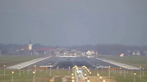 Rear view of a small light aircraft landing on the runway Stock Footage 237183271