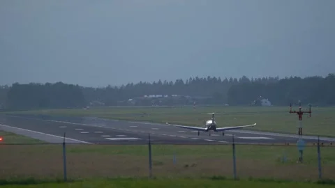 Rear view of a small ultralight airplane landing on the runway Stock Footage 252121008