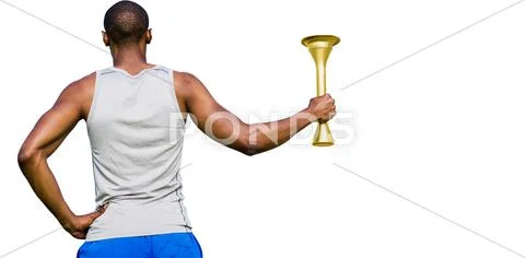 Rear view of sportsman holding a cup Stock Photos